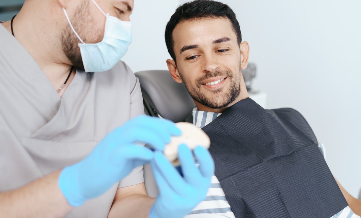Dentist performing dental procedure on young woman