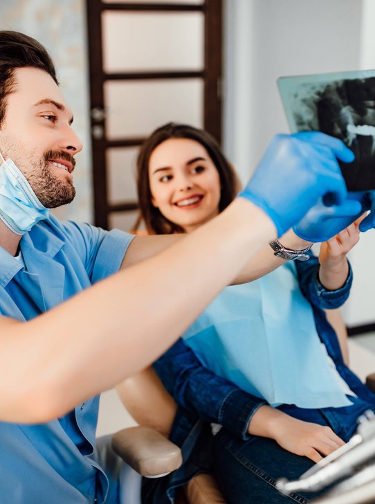 Dentist and hygienist reviewing patient dental records in Oak Harbor