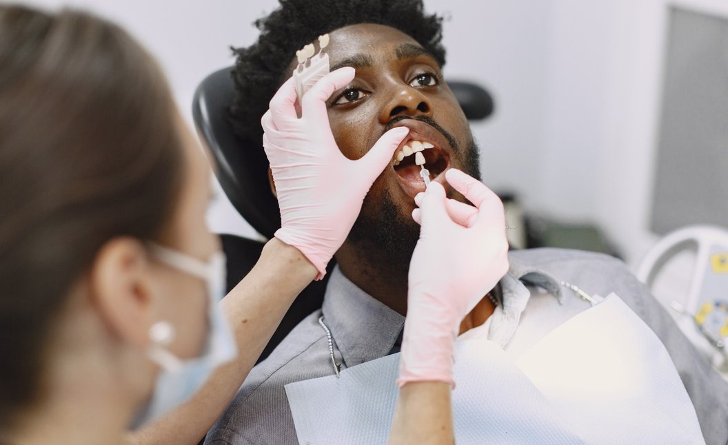 Dentist performing dental procedure on patient with protective eyewear